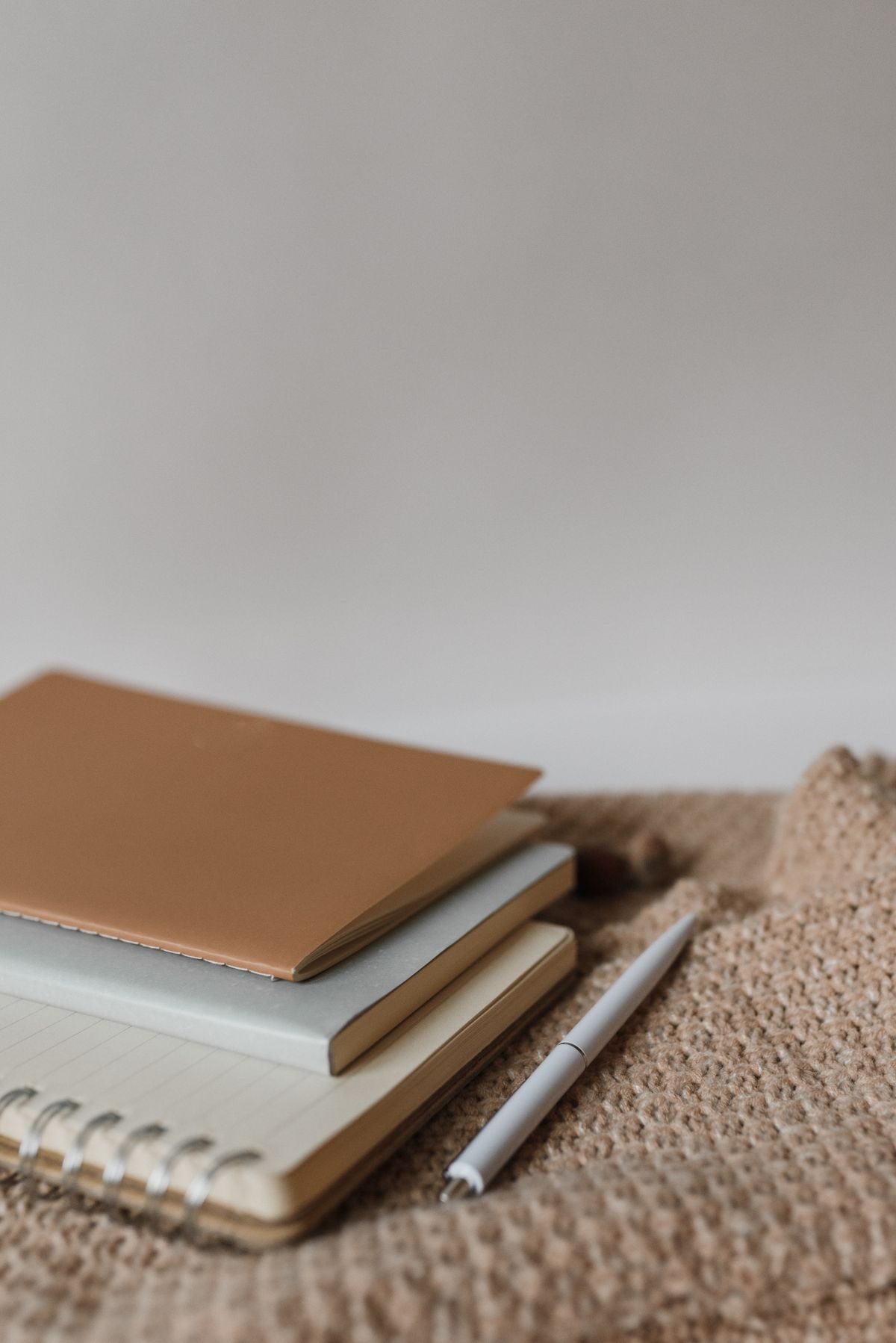 Notebooks and pen on a natural textile